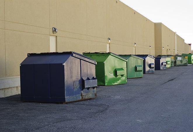 a waste management truck unloading into a construction dumpster in Aransas Pass, TX